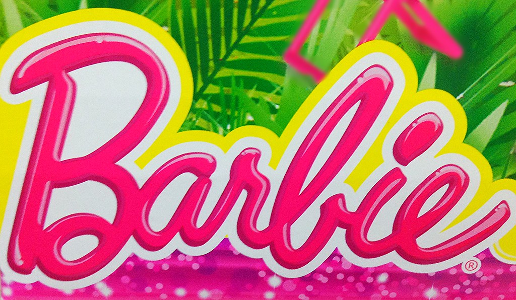 A closeup of a hot pink barbie sign that reads the word, barbie, written in the company Mattel Inc.'s signature curly font.